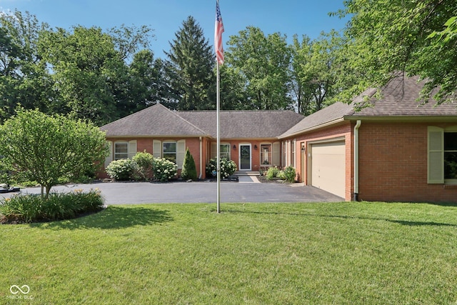 7029 Kingswood Cir, Indianapolis, IN 46256 - ranch-style house featuring brick siding, asphalt driveway, an attached garage, and a front yard