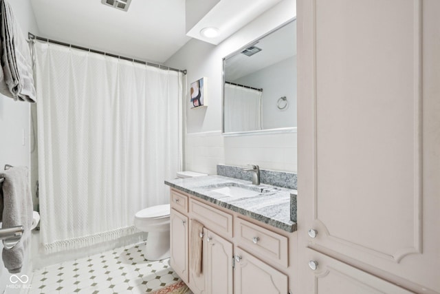 7029 Kingswood Cir, Indianapolis, IN 46256 - bathroom featuring vanity, tile walls, curtained shower, tile patterned flooring, and wainscoting