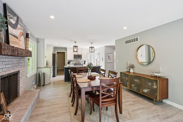 7029 Kingswood Cir, Indianapolis, IN 46256 - dining area with light wood-style flooring, recessed lighting, and a fireplace