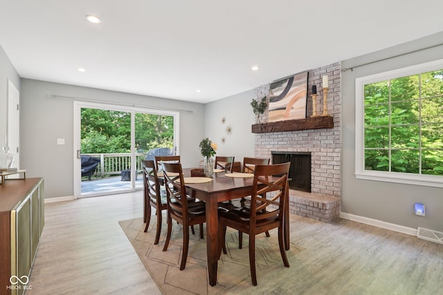 7029 Kingswood Cir, Indianapolis, IN 46256 - dining room featuring light wood-type flooring, a fireplace, and recessed lighting