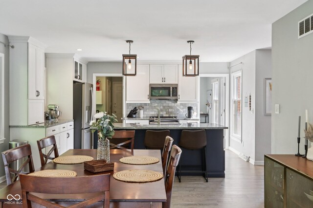 7029 Kingswood Cir, Indianapolis, IN 46256 - dining area with wood finished floors and recessed lighting