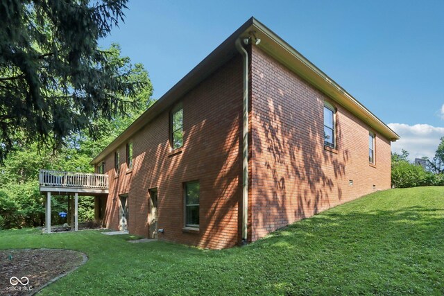 7029 Kingswood Cir, Indianapolis, IN 46256 - rear view of property with brick siding, a lawn, and a deck