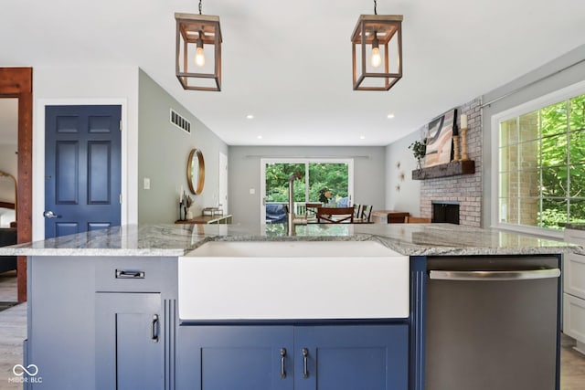 7029 Kingswood Cir, Indianapolis, IN 46256 - kitchen with dishwasher, open floor plan, light stone counters, a brick fireplace, and blue cabinets