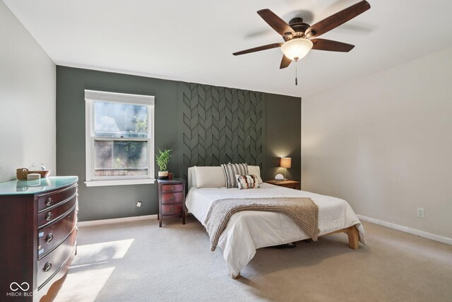 7029 Kingswood Cir, Indianapolis, IN 46256 - bedroom featuring an accent wall, light colored carpet, and ceiling fan