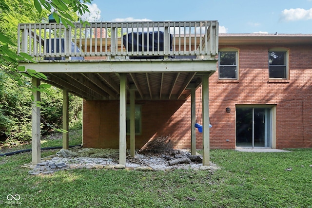 7029 Kingswood Cir, Indianapolis, IN 46256 - rear view of property with a deck, a lawn, and brick siding