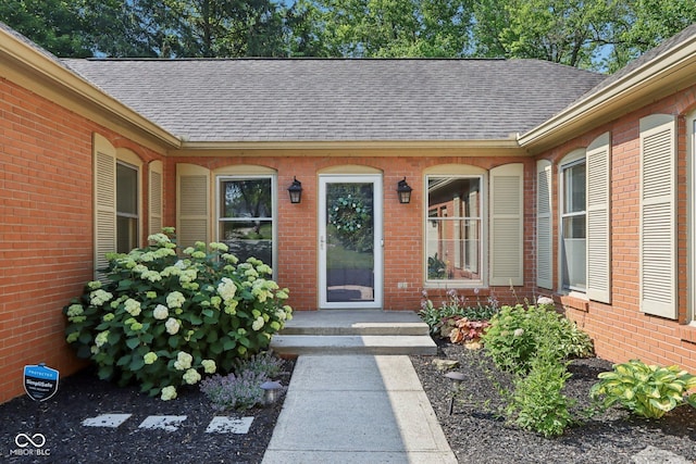 7029 Kingswood Cir, Indianapolis, IN 46256 - view of exterior entry featuring a shingled roof and brick siding