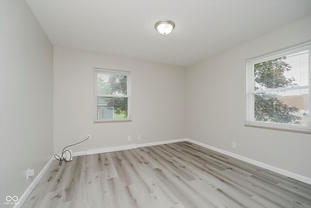 91 N Raceway Rd, Indianapolis, IN 46234 - unfurnished room with healthy amount of natural light and wood finished floors