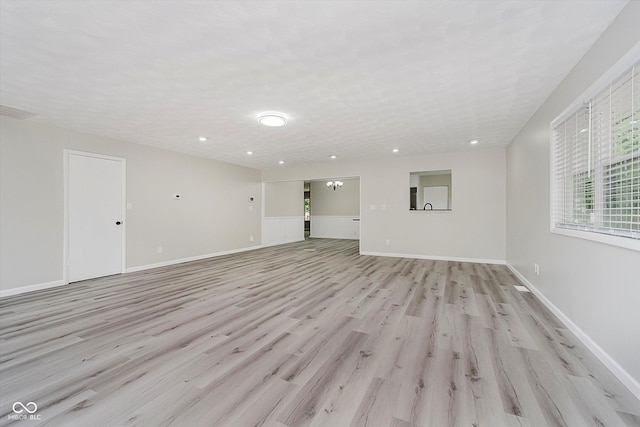 91 N Raceway Rd, Indianapolis, IN 46234 - unfurnished living room featuring light wood finished floors and recessed lighting