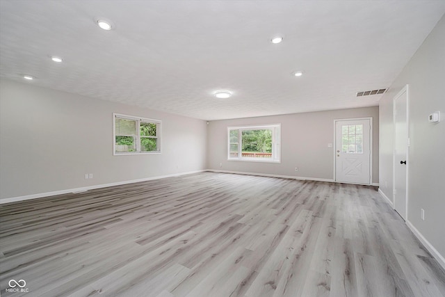 91 N Raceway Rd, Indianapolis, IN 46234 - unfurnished living room with light wood-style flooring and recessed lighting