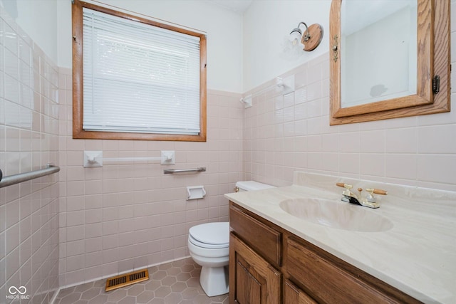 91 N Raceway Rd, Indianapolis, IN 46234 - bathroom featuring tile walls, vanity, and tile patterned flooring