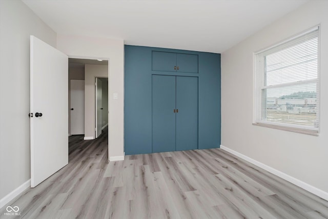 91 N Raceway Rd, Indianapolis, IN 46234 - unfurnished bedroom with light wood finished floors and a closet