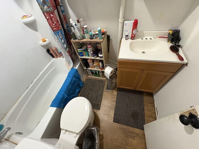 1809 E 13th St, Muncie, IN 47302 - full bath with vanity, wood finished floors, and shower / tub combo with curtain