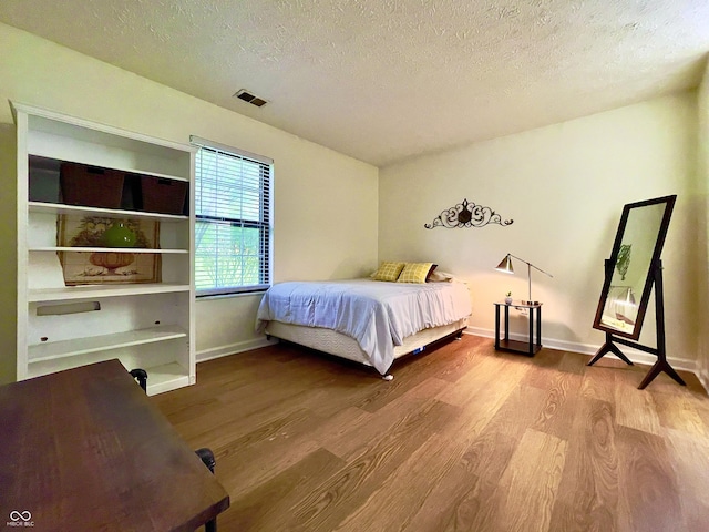 7392 S Meridian St, Indianapolis, IN 46217 - bedroom featuring wood finished floors and a textured ceiling