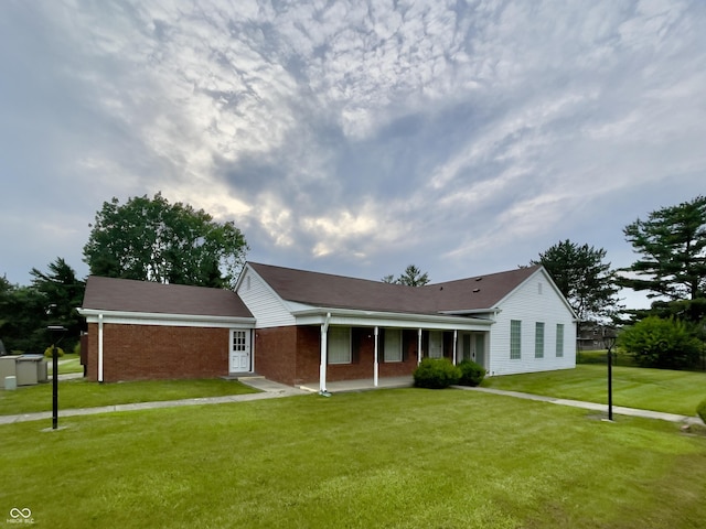 7392 S Meridian St, Indianapolis, IN 46217 - single story home with a porch, a front lawn, and brick siding