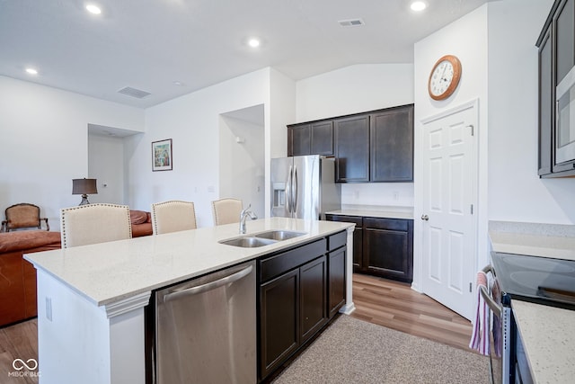 6608 W Shoreline Ct, Greenfield, IN 46140 - kitchen featuring stainless steel appliances, open floor plan, a center island with sink, recessed lighting, and light stone countertops
