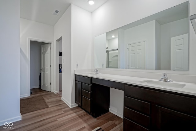 6608 W Shoreline Ct, Greenfield, IN 46140 - bathroom featuring double vanity, wood finished floors, and an enclosed shower