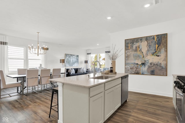 703 Penrose Pl, Danville, IN 46122 - kitchen featuring appliances with stainless steel finishes, a chandelier, dark wood-style floors, a kitchen island with sink, and recessed lighting