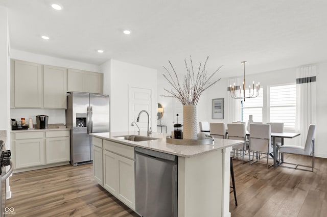 703 Penrose Pl, Danville, IN 46122 - kitchen with stainless steel appliances, a chandelier, light wood-style floors, a kitchen island with sink, and recessed lighting