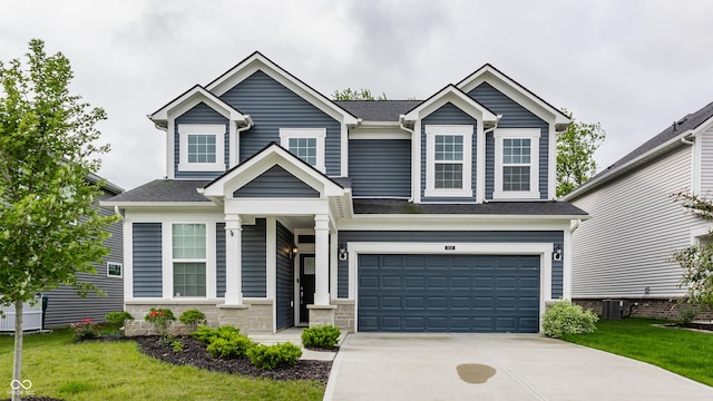 6537 Seabiscuit Rd, Whitestown, IN 46075 - view of front of home featuring concrete driveway, a garage, a front yard, roof with shingles, and stone siding