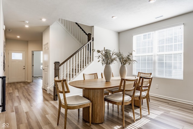 6537 Seabiscuit Rd, Whitestown, IN 46075 - dining area with light wood-type flooring, stairway, and recessed lighting