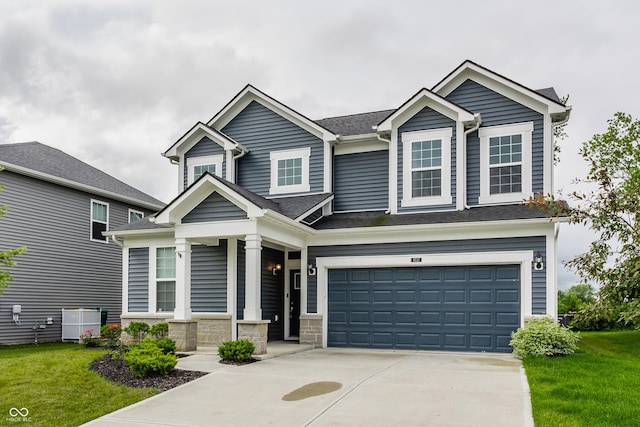 6537 Seabiscuit Rd, Whitestown, IN 46075 - craftsman house featuring concrete driveway, a garage, a front lawn, and covered porch