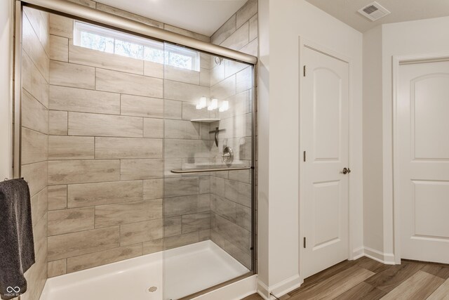 6537 Seabiscuit Rd, Whitestown, IN 46075 - bathroom with a stall shower and wood finished floors