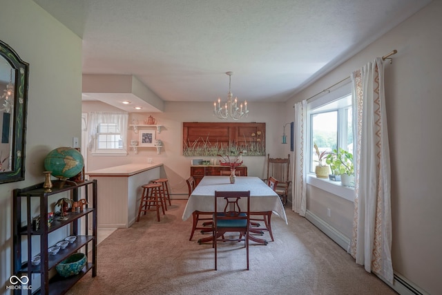 1524 Northcrest Dr, Anderson, IN 46012 - dining area featuring baseboard heating, light carpet, and a chandelier