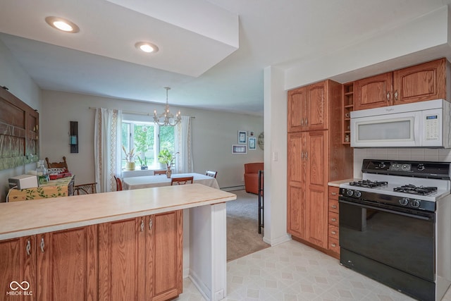 1524 Northcrest Dr, Anderson, IN 46012 - kitchen with white microwave, black gas stove, a chandelier, brown cabinetry, and light countertops