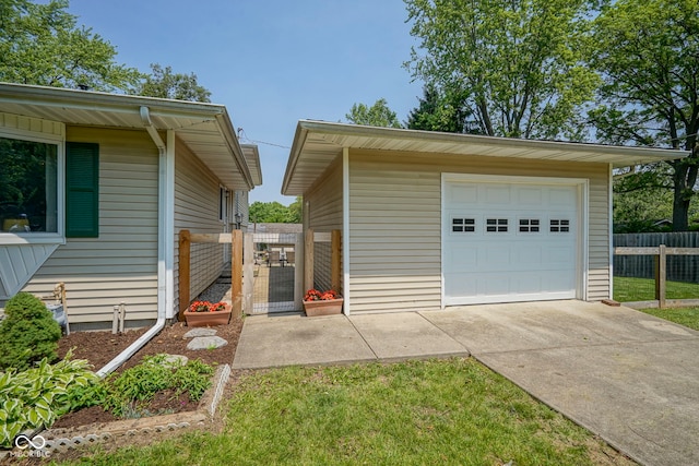 1524 Northcrest Dr, Anderson, IN 46012 - view of side of home with driveway, an outbuilding, and a garage