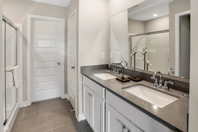 19820 Moorpark Lndg, Noblesville, IN 46062 - bathroom with a stall shower, double vanity, and wood finished floors