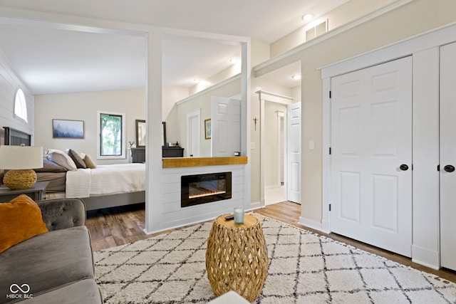 17320 Joliet Rd, Westfield, IN 46074 - bedroom featuring a glass covered fireplace and wood finished floors