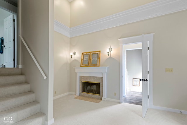 17320 Joliet Rd, Westfield, IN 46074 - living area with light carpet, a tiled fireplace, and stairs