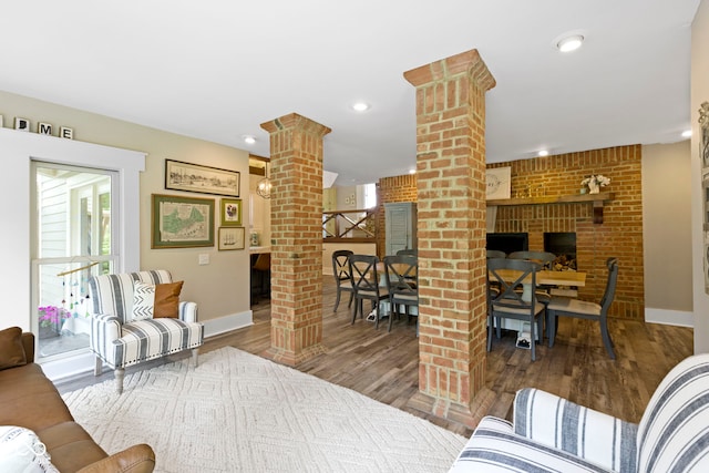 17320 Joliet Rd, Westfield, IN 46074 - living area featuring decorative columns, a brick fireplace, wood finished floors, and recessed lighting