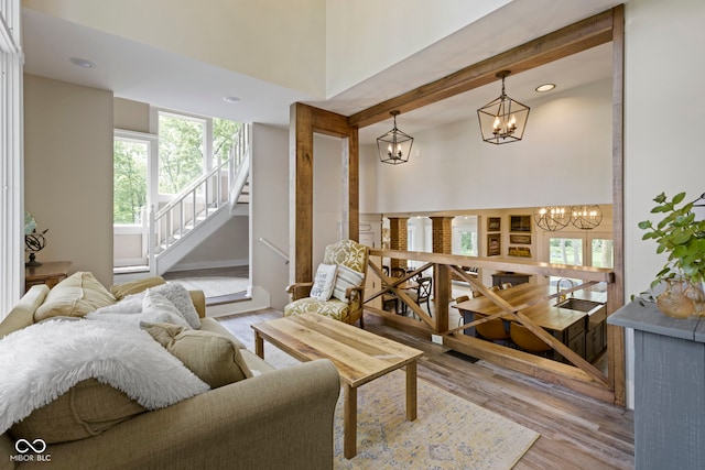 17320 Joliet Rd, Westfield, IN 46074 - living room featuring a chandelier, plenty of natural light, wood finished floors, recessed lighting, and stairs