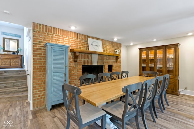 17320 Joliet Rd, Westfield, IN 46074 - dining area with light wood-style floors, a brick fireplace, and recessed lighting