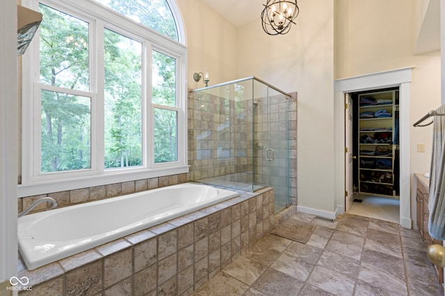 17320 Joliet Rd, Westfield, IN 46074 - bathroom featuring a bath, a stall shower, vanity, a spacious closet, and stone tile flooring