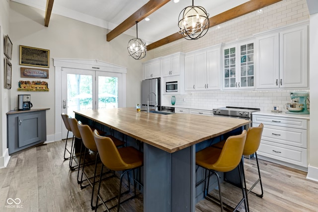 17320 Joliet Rd, Westfield, IN 46074 - kitchen featuring appliances with stainless steel finishes, butcher block countertops, beamed ceiling, a chandelier, and decorative backsplash