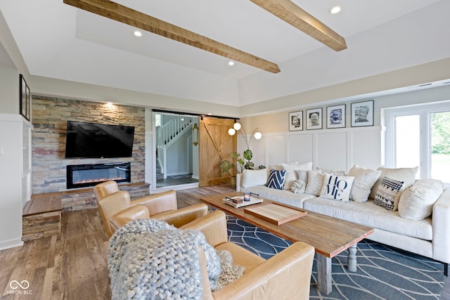 17320 Joliet Rd, Westfield, IN 46074 - living room featuring wood finished floors, beamed ceiling, a fireplace, recessed lighting, and a decorative wall