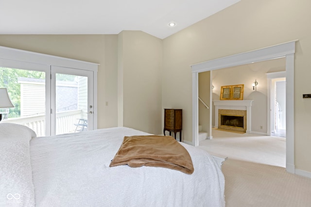17320 Joliet Rd, Westfield, IN 46074 - bedroom featuring vaulted ceiling, access to exterior, light colored carpet, and a fireplace with flush hearth