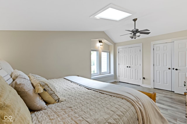 17320 Joliet Rd, Westfield, IN 46074 - bedroom with multiple closets, a skylight, wood finished floors, lofted ceiling, and a ceiling fan