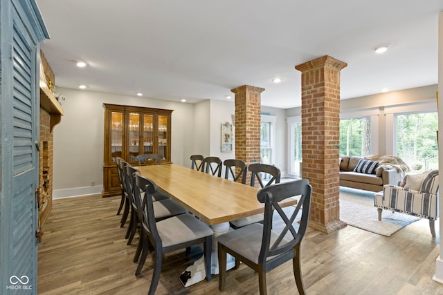 17320 Joliet Rd, Westfield, IN 46074 - dining area with ornate columns, a brick fireplace, light wood-style flooring, and recessed lighting