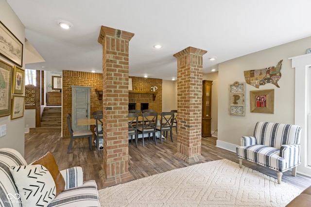 17320 Joliet Rd, Westfield, IN 46074 - living room featuring decorative columns, wood finished floors, a brick fireplace, and recessed lighting