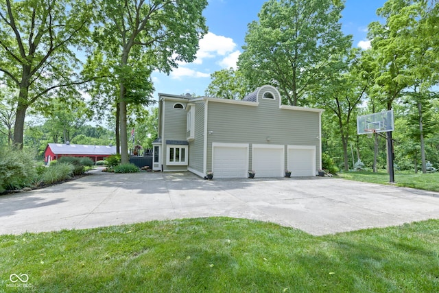17320 Joliet Rd, Westfield, IN 46074 - view of side of property featuring concrete driveway, an attached garage, and a yard