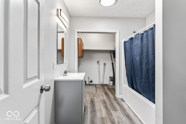 3529 Hunt St, Plainfield, IN 46168 - full bathroom featuring vanity, wood finished floors, a textured ceiling, and shower / bath combo