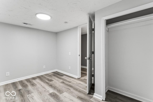 3529 Hunt St, Plainfield, IN 46168 - unfurnished bedroom with wood finished floors and a textured ceiling