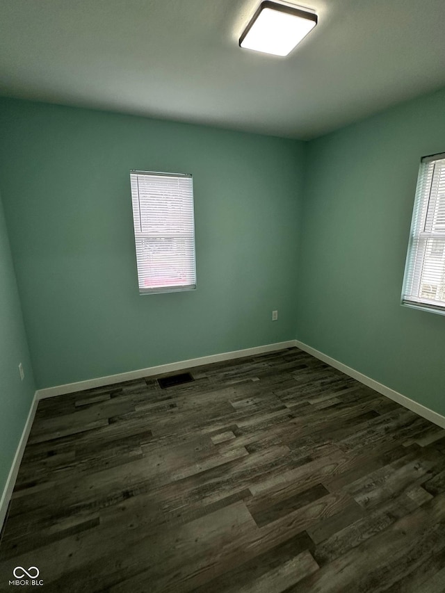 4715 Normal Ave, Indianapolis, IN 46226 - empty room with dark wood-style flooring and baseboards
