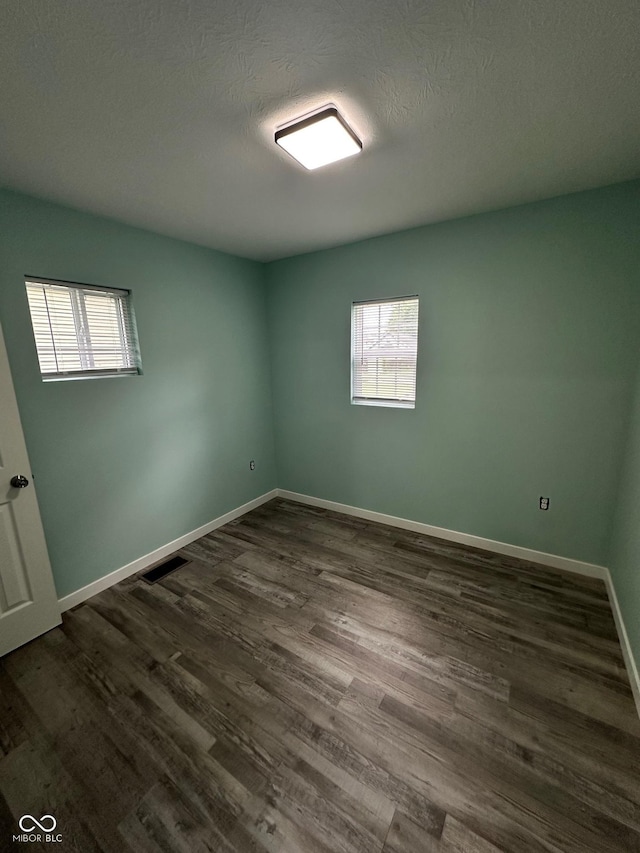 4715 Normal Ave, Indianapolis, IN 46226 - empty room featuring dark wood-type flooring and a textured ceiling