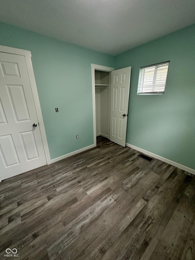 4715 Normal Ave, Indianapolis, IN 46226 - unfurnished bedroom with dark wood finished floors and a closet