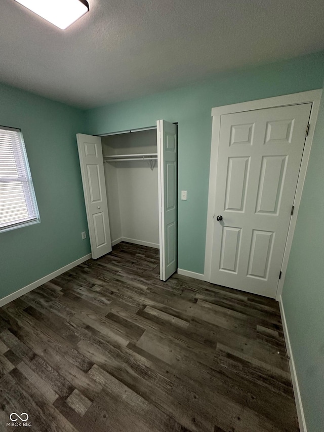 4715 Normal Ave, Indianapolis, IN 46226 - unfurnished bedroom featuring dark wood finished floors and a closet