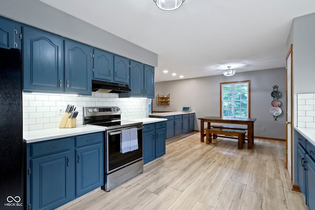10808 Greenbriar Dr, Fishers, IN 46037 - kitchen featuring stainless steel range with electric cooktop, under cabinet range hood, blue cabinets, decorative backsplash, and light countertops
